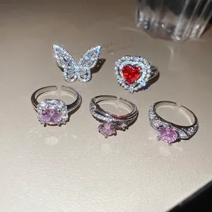 Five-piece set of silver-toned rings featuring pink zircon, butterfly and red heart designs