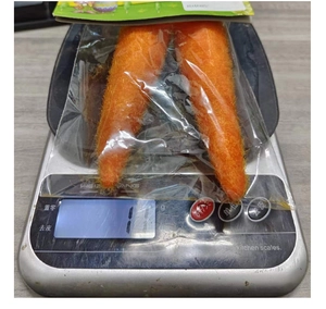 Detail view of plush Easter carrot decorations on a kitchen scale showing light weight