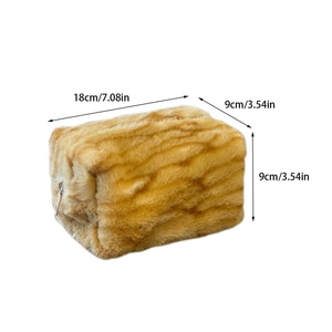 Detail view of plush makeup bag dimensions 18x9x9cm with golden wavy faux fur texture