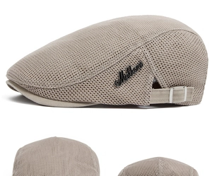 Detail view of breathable mesh texture and metal side logo on the beige flat cap