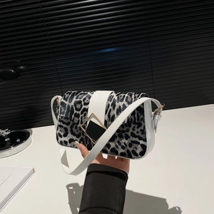 Minimalist winter baguette bag with black and white leopard print faux fur and gold buckle