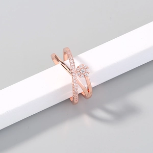 Elegant rose gold criss-cross ring featuring micro-paved white zircons and floral motif