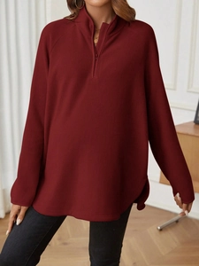 Women's burgundy fleece maternity quarter-zip pullover in a relaxed casual fit