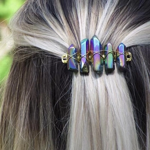 Handmade hair clip featuring five raw rainbow crystals woven with golden wire on blonde hair