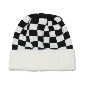 Detailed close-up showing the soft texture and knit pattern of checkerboard beanie