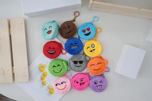 Close-up of colorful plush emoji coin purses with metal hooks and zipper closures