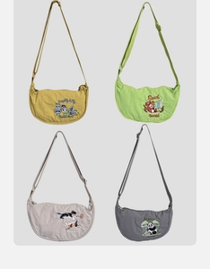 Detailed grid view of four canvas crescent crossbody bags with animal embroidery patterns