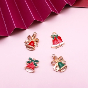 Macro detail of Christmas bell charms with red and green enamel for DIY jewelry making