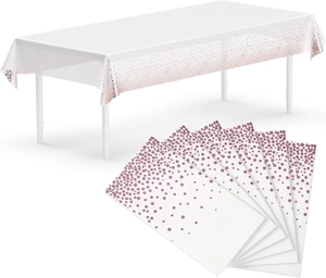 Detail of disposable rose gold polka dot tablecloth and matching paper napkins set