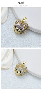Detailed macro view of 18K gold plated bear pendants with purple and white zircon crystals