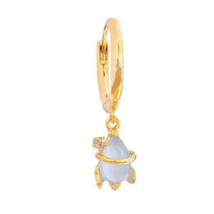 Detail of 18K gold rocket earring featuring a light blue gemstone and white zircon accents