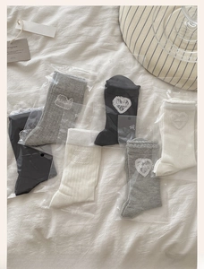Detail of sweet heart embroidery and wavy lace cuffs on cotton mesh crew socks