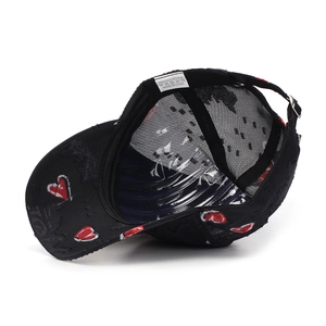Detail view of adjustable metal buckle and breathable mesh on black heart baseball cap