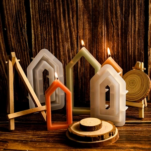 Detailed view of hollow house-shaped silicone molds and DIY geometric candle samples