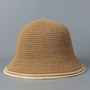 Detailed macro view of woven straw bucket hat texture with beige edge stitching decoration