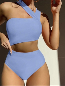 Detail of light blue high-waisted bikini featuring one-shoulder cutout and asymmetric design
