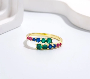 Close-up of adjustable gold ring featuring vibrant multi-colored inlaid zircon stones
