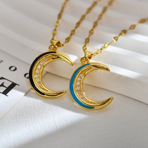 Golden crescent moon pendant necklace with enamel details and white zircon pavé