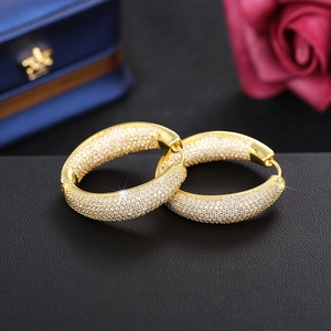 Detailed shot of large gold-tone hoop earrings with micro-pave white cubic zirconia stones