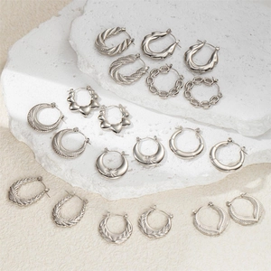 Selection of silver stainless steel earrings featuring rope and chain textures on stone