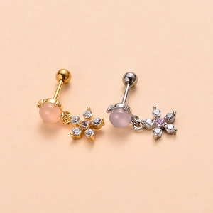 Detail of surgical steel screw back earrings with pink cat eye stone and zircon flower