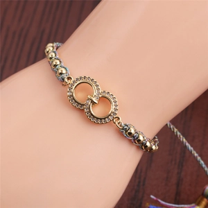 Detailed close-up of woven bead bracelet with micro-pave zircon interlocking rings