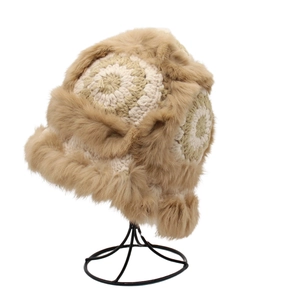 Detailed close-up of knit texture and faux fur lining on a winter trapper hat