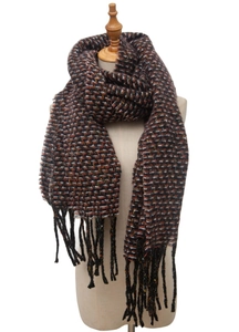 Close-up of deep brown thick knit scarf with fringe detail and tweed pattern on model
