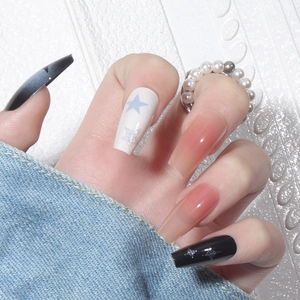 Long trapezoid press-on nails with star patterns in black and blue glitter on white background