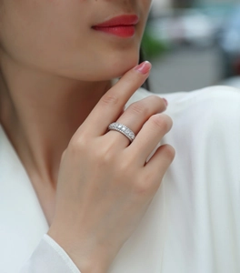 Close-up of a multi-row moissanite sterling silver ring on a model's hand