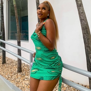 Green sleeveless halter neck mini dress with abstract print and side drawstring ruching