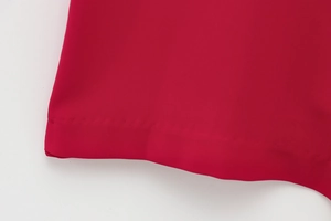 Detailed close-up of the double-needle hem stitching on the dark red summer jumpsuit