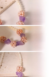 Macro detail of natural freshwater pearls and amethyst flower pendant on a gold chain