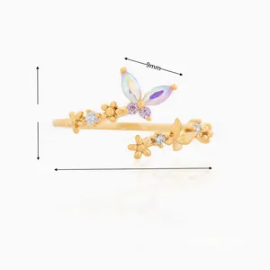 Detailed view of gold butterfly wrap ring with purple gradient wings and white zircon flowers