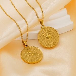 Vintage 18K gold plated Leo and Cancer zodiac coin pendant necklaces on silk background