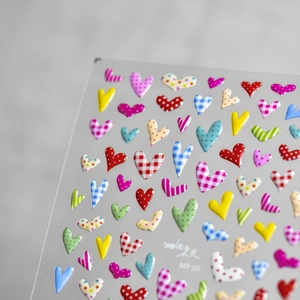 Close-up of MS-339 heart nail stickers with embossed textures and colorful patterns
