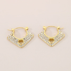 Vue détaillée des boucles d'oreilles cœur dorées avec design évidé et cristaux brillants