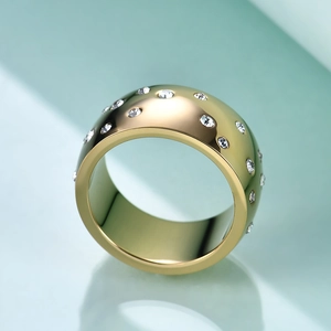 Macro shot of 10mm gold wide band ring featuring a stardust pattern with clear crystals