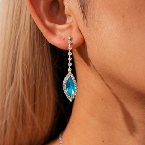 Detailed view of silver drop earrings with sea blue marquise cut crystals and fringe