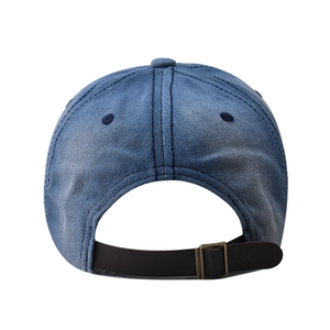 Close-up of washed blue denim baseball cap with leather adjustable strap and metal buckle