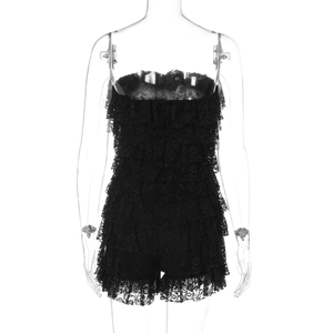 Detail of black tiered lace tube romper showing intricate ruffled patterns and fabric texture