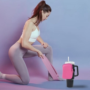 Pink neoprene pouch for 40oz tumbler shown in fitness workout scene on a black mug