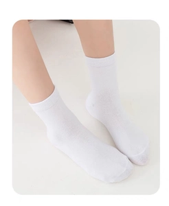 Close-up of white cotton children socks showing soft breathable fabric and ribbed texture