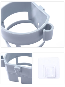 Detail view of grey wall-mounted hair dryer holder with adhesive patch and side hooks