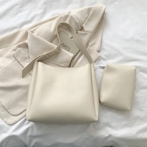 Detail of minimalist beige tote bag with matching coin purse on neutral background