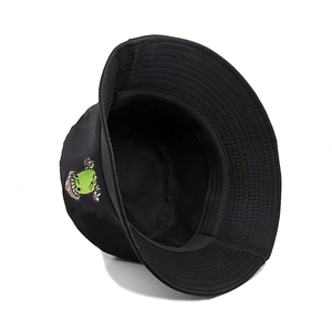 Detail of cute mushroom and frog embroidery on a black cotton canvas bucket hat