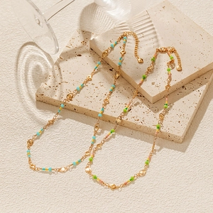 Colorful beaded choker necklace in 18K gold plated copper on natural stone background