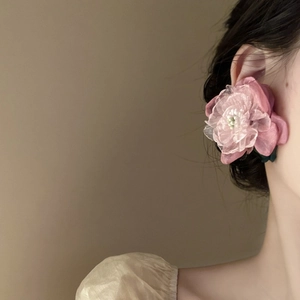 Pink tulle 3D flower drop earrings with pearls and green leaves on female model