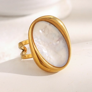 Macro detail of 18K gold plated ring featuring an oval white shell stone and hollow band