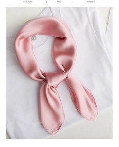 Detail of elegant pink silk scarf styled on white t-shirt for daily minimalist fashion